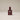 Perfume bottle labeled 'Gentle Habits Heartfire' on a beige background
