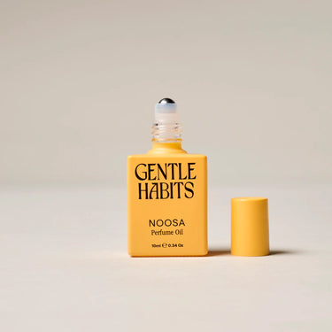 Yellow bottle of Gentle Habits Noosa Perfume Oil on a beige background