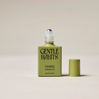 Green bottle of 'Yamba' perfume oil by 'Gentle Habits' on a beige background