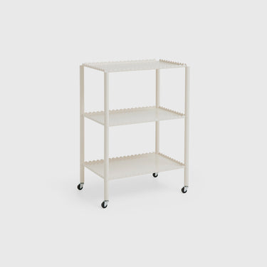 A red Arcs Trolley High with two tiers, mounted on castors, featuring a unified chain of vertical arcs design. It is displayed in a room with wooden wall paneling.