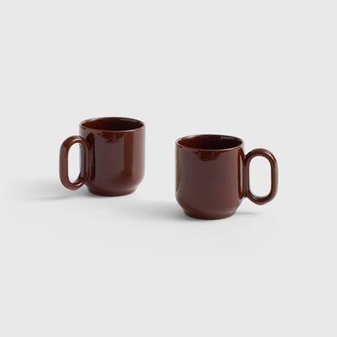 Two brown mugs on a light gray background