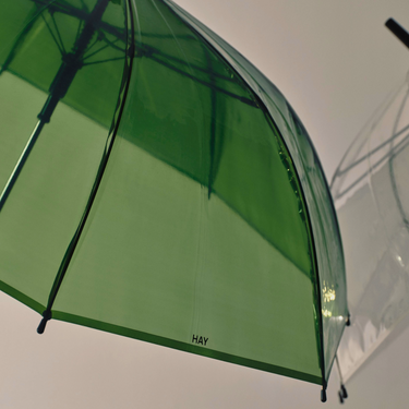 Green umbrella with 'HAY' branding on a white background