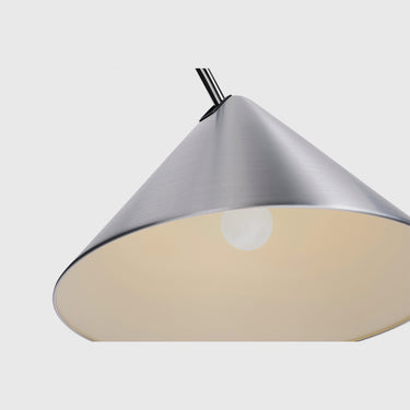 A modern pendant light with a brushed silver metal cone shade and a warm cream-colored interior, shown against a light gray background.