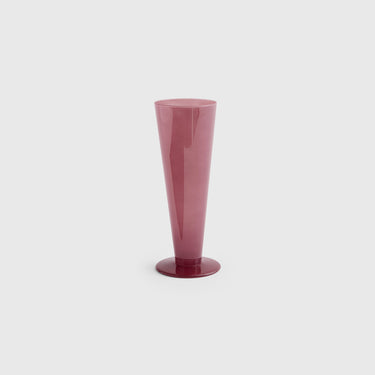Pink glass vase on a light gray background