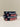 Set of striped dog collars with 'HAY' branding on a light surface.