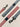 Striped dog leashes in red, white, and blue with black metal clips on a beige background.