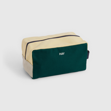 Two-tone beige and green pouch with 'HAY' branding on a light gray background