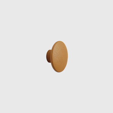 Burnt orange wall hook on a light grey background