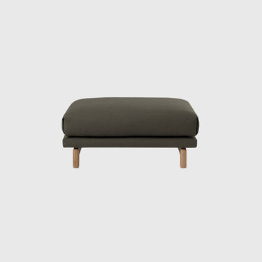 A modern rectangular ottoman with a dark green textured fabric upholstery and light natural wood legs, shown against a solid light gray background.