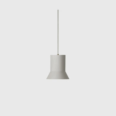 A minimalist pendant light with a matte gray cylindrical shade and a thin vertical rod, suspended against a solid light gray background.