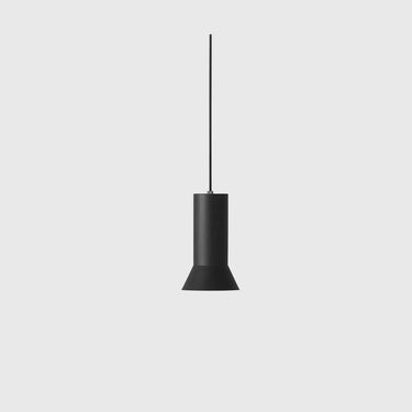 A minimalist black pendant light with a cylindrical shade and a thin hanging cord, centered against a solid light gray background.