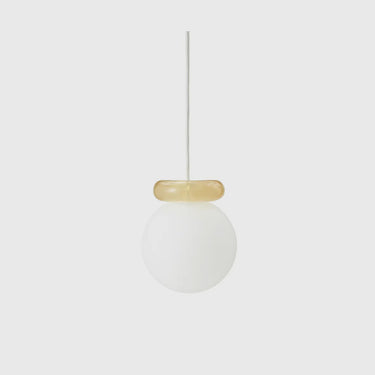 A modern pendant light with a frosted white glass globe shade and a translucent amber glass collar, suspended by a thin white cord against a light gray background.