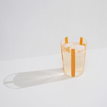 The Conran Shop - Nova Stripe Glasses 500ml ( Set of 4) - Orange single glass with clear drink and ice cube