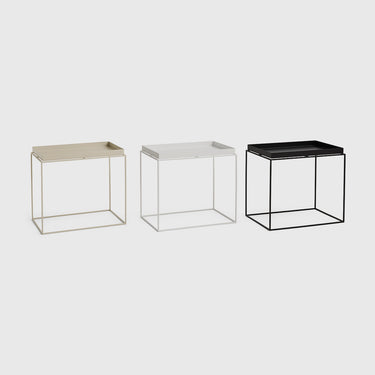 Three modern wire-frame side tables in gold, silver, and black finishes, arranged side-by-side on a light gray background.