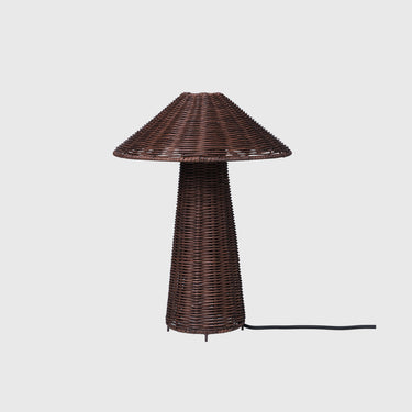 A dark brown woven wicker table lamp with a conical shade and matching tapered base, shown against a light gray background with a black power cord extending to the right.