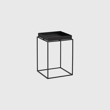 A modern black side table featuring a square tray top and an open cube wireframe base, shown on a light gray background.