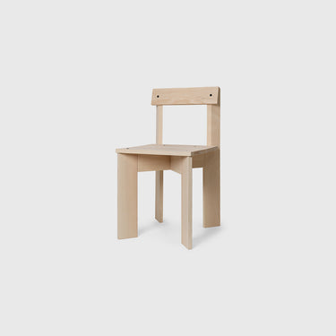 Ash dining chair made from various pieces of wood joining together on a white grey background.