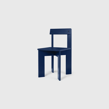 A blue dining chair with a hard backrest and seat, made of solid wooden planks.
