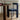Blue wooden lacquered chair with dark stained oak round dining table in a well lit room. 