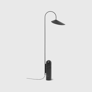 An Arum Floor Lamp with a black marble base and an off-white lampshade, featuring a curved metal arch. The lamp is turned off and has a matte finish.