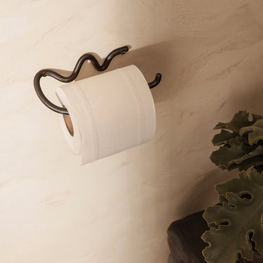 Interior image of a curvature toilet paper holder in a bathroom setting
