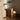 Dark brown side table interior image with lamp in bedroom. 