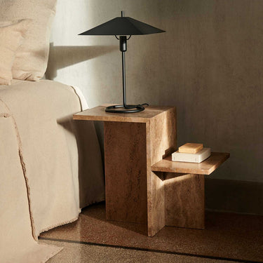 Dark brown side table interior image with lamp in bedroom. 